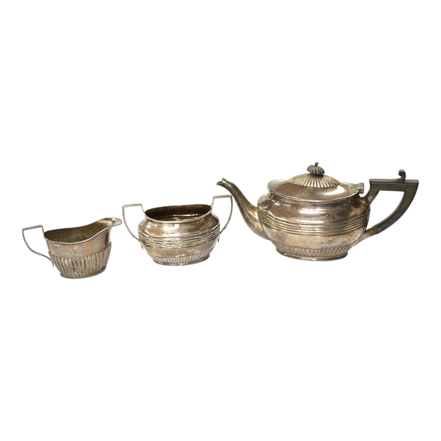 A matched late 19th/early 20th century silver three piece bachelor's tea set, two dates and makers, gross weight 13.5oz. Condition - poor